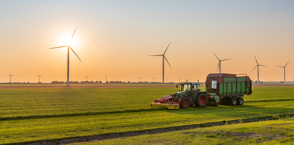Tractor with wind turbines in background